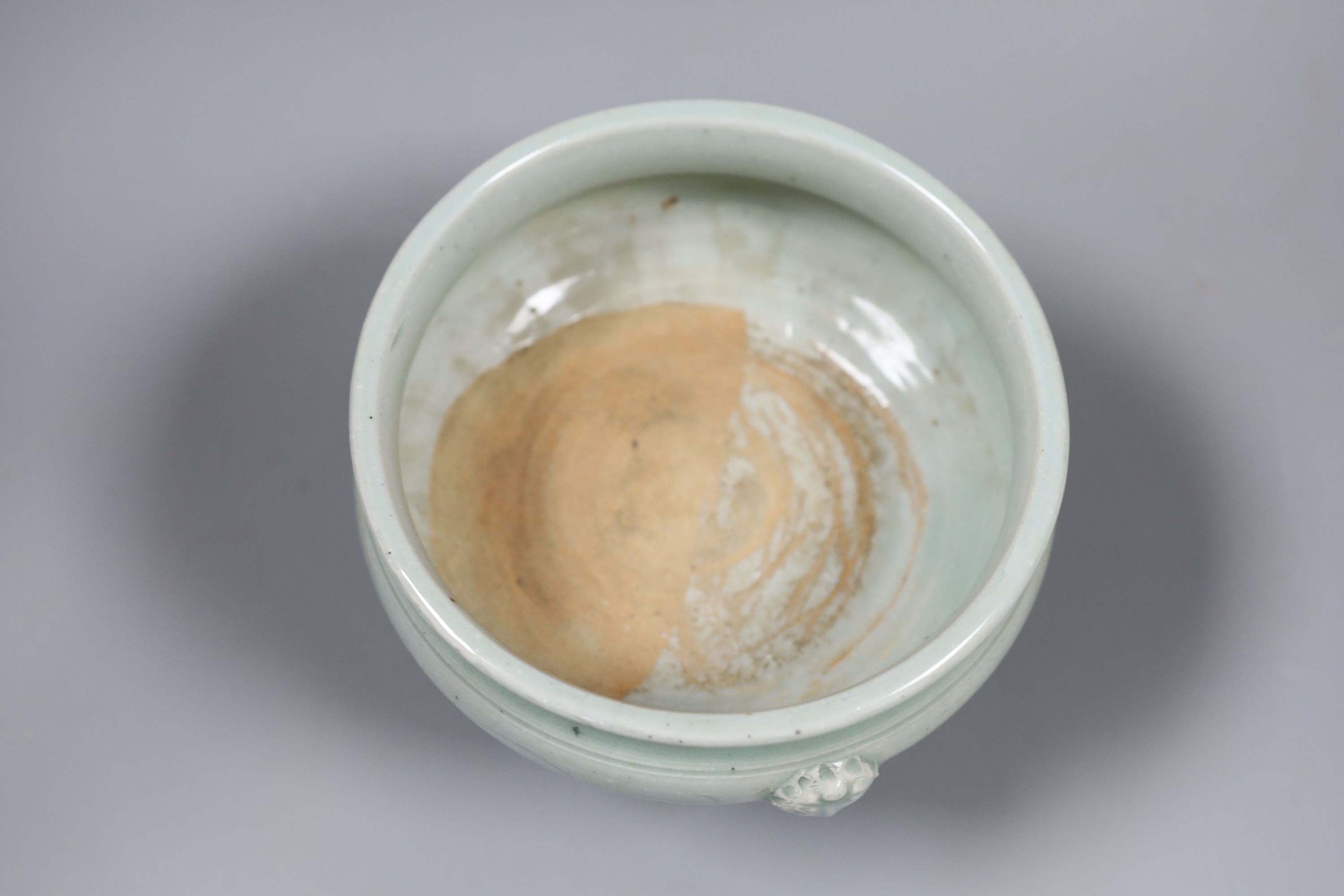 A Chinese celadon tripod censer, Ming or later, 16.5 cm diameter